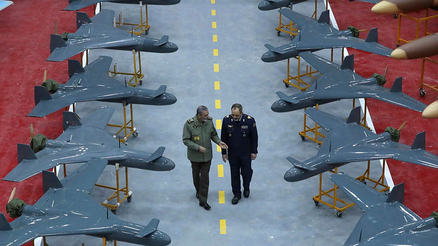 Iran's army commander Gen Abdolrahim Mousavi speaks with Defence Minister Gen Aziz Nasirzadeh in a ceremony to deliver domestically-built drones to the army, 13 January 2025