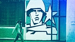 FILE: A woman walks past the Operational Group of Russian Forces headquarters in Tiraspol, the capital of the breakaway region of Transnistria, in Moldova, 1 November, 2021