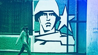 FILE: A woman walks past the Operational Group of Russian Forces headquarters in Tiraspol, the capital of the breakaway region of Transnistria, in Moldova, 1 November, 2021
