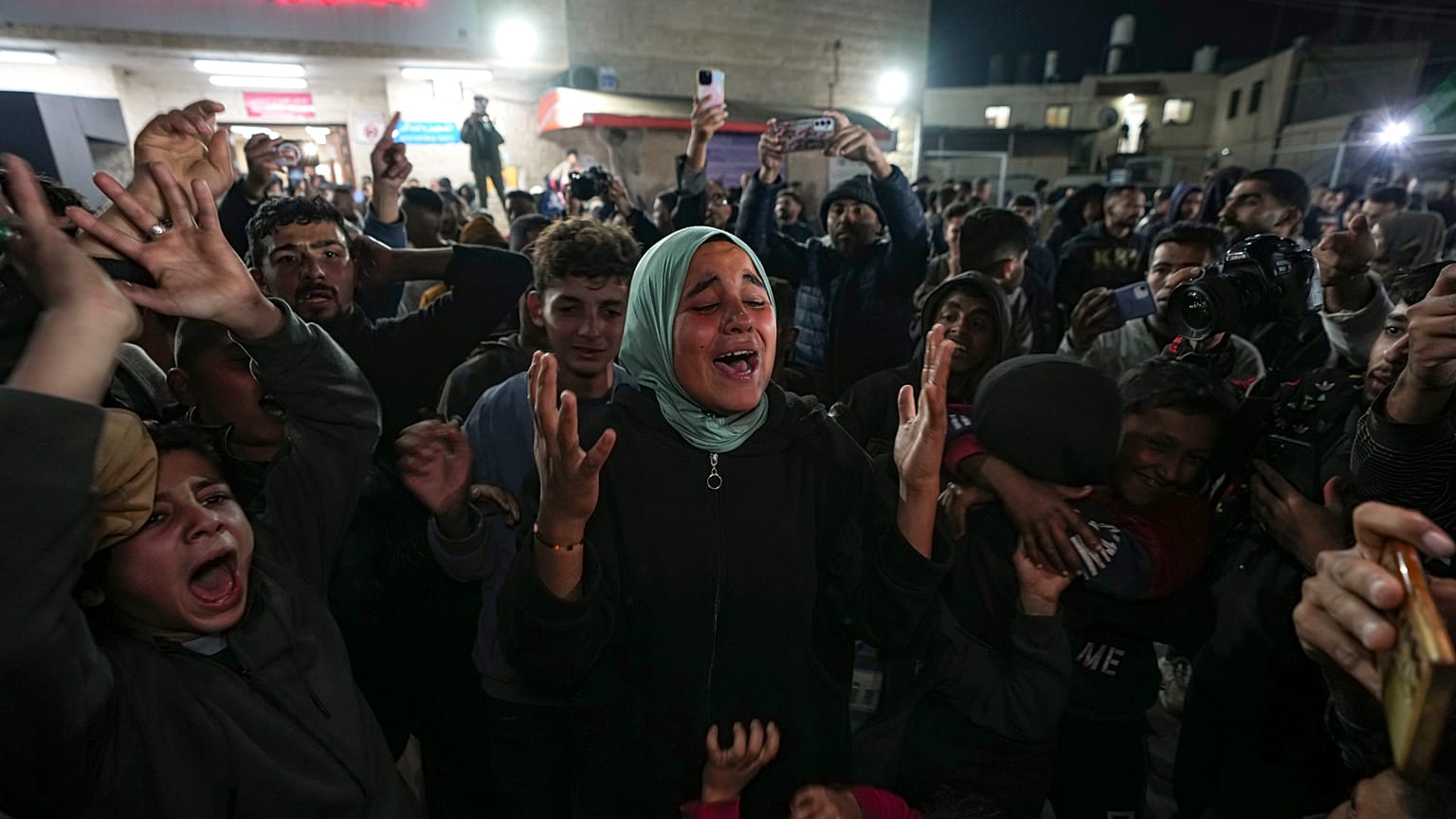 Palestinesi festeggiano l'annuncio di un accordo di cessate il fuoco tra Hamas e Israele a Deir al-Balah