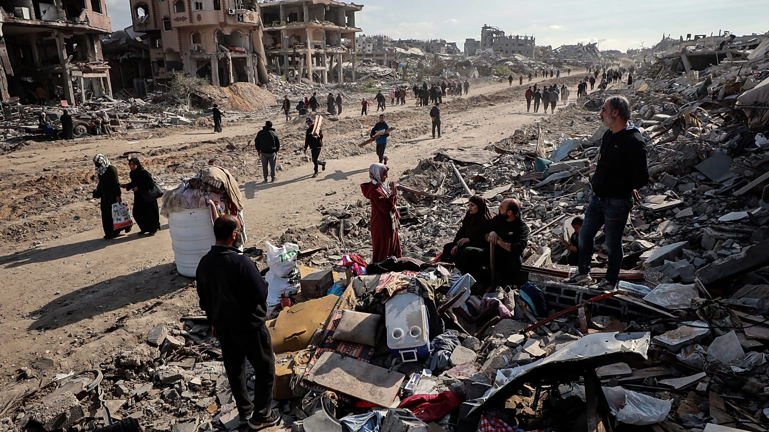 Palestinianos inspeccionam a destruição causada pela ofensiva aérea e terrestre israelita em Jabaliya, 19 de janeiro de 2025