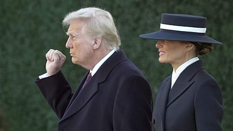 President-elect Donald Trump gestures as he walks with his wife Melania after a church service across from the White House in Washington, 20 January 2025