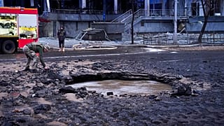A Ukrainian serviceman collects evidence following a Russian missile attack in Kyiv, Ukraine, Saturday, Jan. 18, 2025.