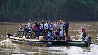 Residents cross a river to Venezuela from Colombia's Tibu, Tuesday, 21 Jan, 2025, following guerrilla attacks that killed dozens and forced thousands to flee their homes.