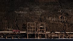 A firetruck and a pickup truck move past homes destroyed by the Palisades Fire along the coastline, Friday, Jan. 17, 2025, in Malibu, Calif.