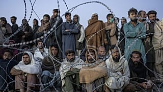 FILE - Afghan refugees wait to register in a camp near the Torkham Pakistan-Afghanistan border in Torkham, Afghanistan, Saturday, Nov. 4, 2023.