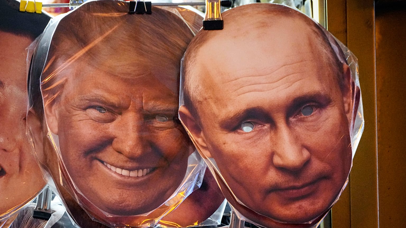 Des masques représentant Donald Trump et Vladimir Poutine sont suspendus parmi d'autres à vendre dans une boutique de souvenirs à Saint-Pétersbourg, Russie, le 20 janvier 2025