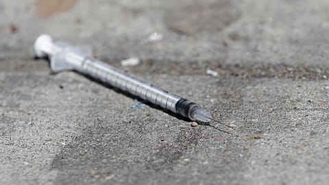 A used syringe is shown on a US sidewalk in this 2018 file photo.