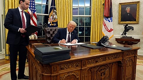 US President Donald Trump signs an executive order withdrawing the US from the WHO in January 2025.
