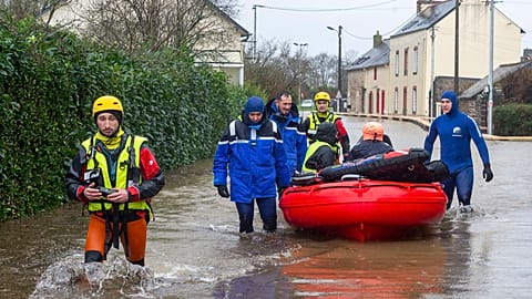  Police officers and rescuers evacuate residents as severe flooding hits western France during Storm Ivo on Wednesday, January 29, 2014, in Redon, western France.