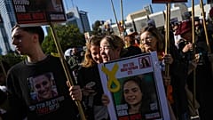 People react as they watch broadcast of the release of Israeli soldier Agam Berger, one of eight hostages set to be released today as part of a ceasefire in the Gaza Strip,