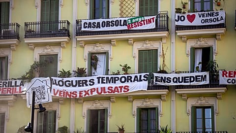 FILE - A block of flats, which is under threat of eviction, in Barcelona, Spain, July 10, 2024.The banner in centre reads: "temporary rental housing: neighbours evicted." 