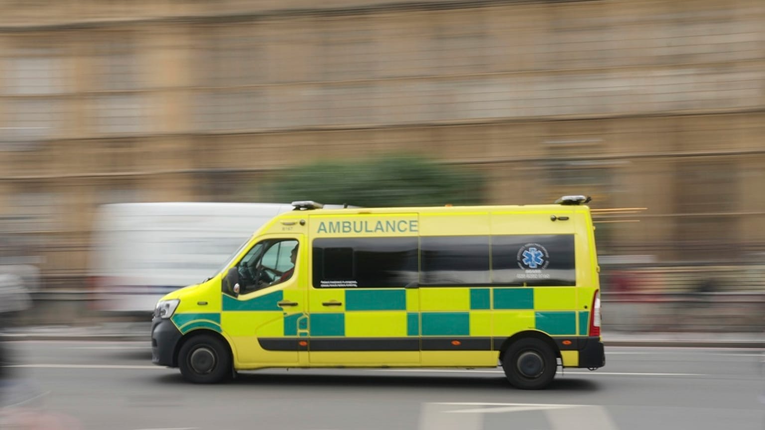 An ambulance drives past the Houses of Parliament as Prime Minister Keir Starmer makes a major speech on the NHS, in London, Thursday, Sept. 12, 2024. (AP Photo/Kin Cheung)