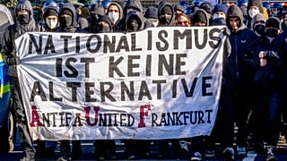 Demonstrators carry a sign reading "nationalism is no alternative" during a protest against an AfD election campaign in Neu Isenburg near Frankfurt, Germany, Saturday, Feb. 1,