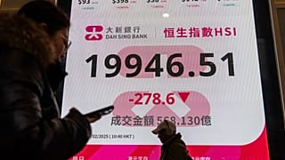 Pedestrians walk past an electronic screen displaying the Hang Seng Index on the first trading day of the Year of Snake in Hong Kong, Monday, Feb. 3, 2025. 