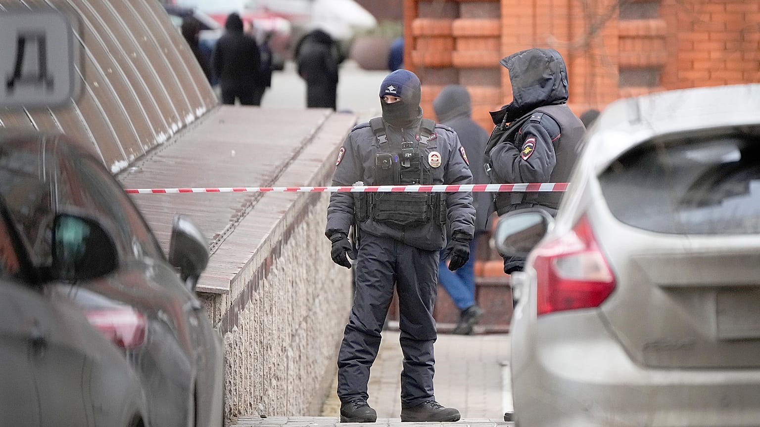 Police officers stand guard in the yard of an upscale residential block in Moscow, 3 February 2025