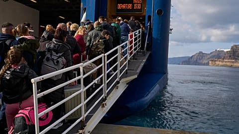 Passengers board a regularly scheduled ferry to Athens' port of Piraeus, after a spike in seismic activity raised concerns about a potentially powerful earthquake in Santorini