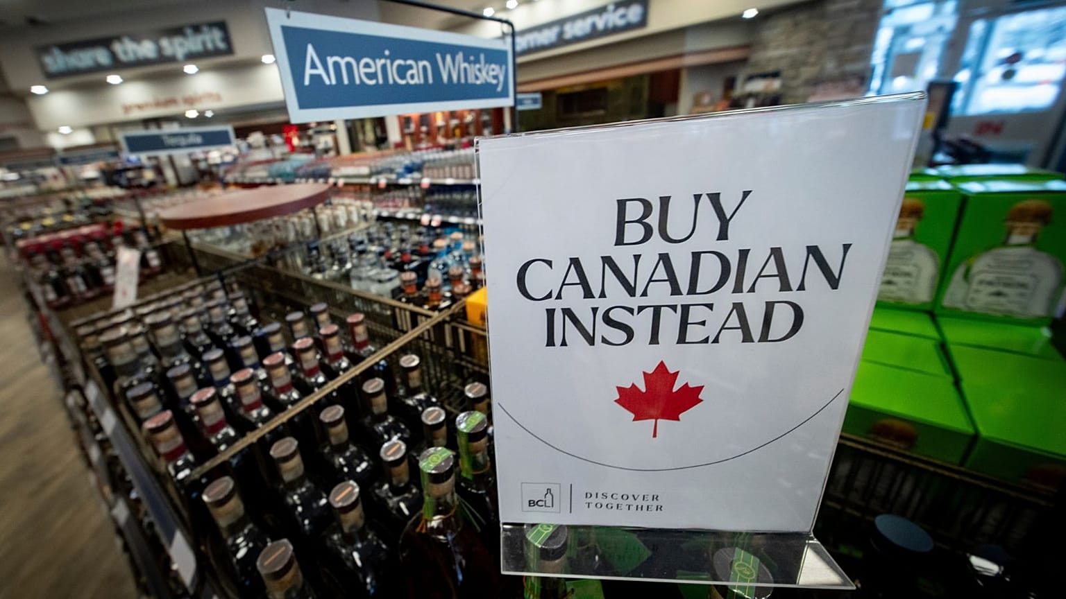 A sign is placed in front of the American whiskey section at a British Columbia liquor store after top selling American made products have been removed from shelves.
