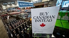 A sign is placed in front of the American whiskey section at a British Columbia liquor store after top selling American made products have been removed from shelves.