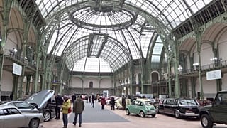 People looking at vintage cars on display at Grand Palais in Paris