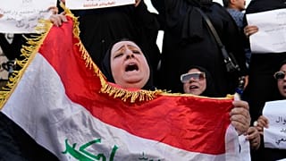 FILE - Protesters gather to demonstrate against a proposed law to permit underage female marriage in Tahrir Square in Baghdad, Iraq, 8 August, 2024.