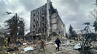 عمال الإنقاذ يسيرون أمام مبنى تضرر بشدة جراء غارة روسية في إزيوم، أوكرانيا. (خدمة الطوارئ الأوكرانية عبر أسوشيتد برس)  4 فبراير/شباط 2025