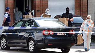 Des policiers et des agents de la police scientifique retirent des objets lors d'une perquisition dans le quartier de Molenbeek à Bruxelles, le mercredi 21 juin 2017.