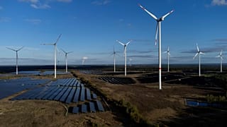Wind turbines spin at the Klettwitz Nord solar energy park near Klettwitz, Germany.