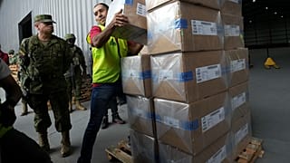 موظف في المجلس الانتخابي الوطني يساعد في تحميل الأدوات الانتخابية في مركز توزيع، استعدادًا للانتخابات العامة يوم الأحد، في كيتو، الإكوادور، السبت 8 فبراير/شباط 2025