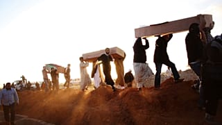 mass grave, at a funeral in Benghazi, Liby