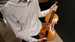 Violinist Stefan Jackiw holds the 1714 Joachim-Ma Stradivarius at Sotheby's auction house in New York, 3 Feb 2025.