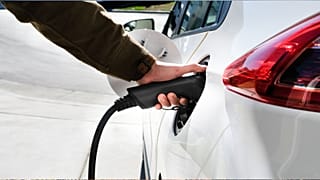 A person charging an electric car.