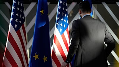 A worker adjusts the US and EU flags prior to the EU-US Energy Council Ministerial meeting on April 4, 2023.