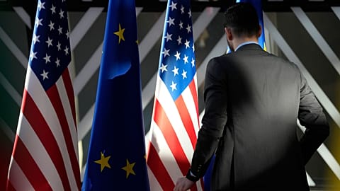A worker adjusts the US and EU flags prior to the EU-US Energy Council Ministerial meeting on April 4, 2023.