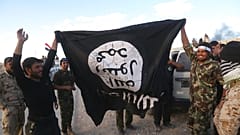 Bu arşiv fotoğrafta, Irak güvenlik güçleri ve müttefik Şii milisler IŞİD bayrağıyla beraber, 31 Mart 2015