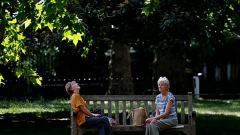 People sit on the bench in London in May 2020.
