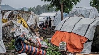 A woman and her child displaced by the fighting between M23 rebels and government soldiers prepare to leave the camp following an instruction by M23 rebels, 11 Feb 2025.