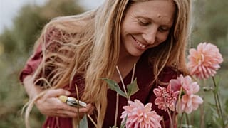 Sammie Hall of Sammie's Flowers cuts her pesticide-free British-grown flowers for sale in the UK