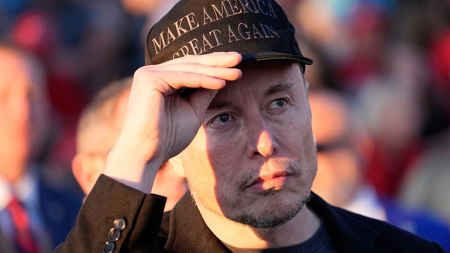  Elon Musk, Başkan Donald Trump Ekim 2024'te Butler Farm Show'daki bir kampanya etkinliğinde konuşurken onu dinliyor.