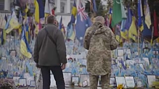 People stand in from of Maiden Square memorial in Kyiv, Ukraine, 2024. 