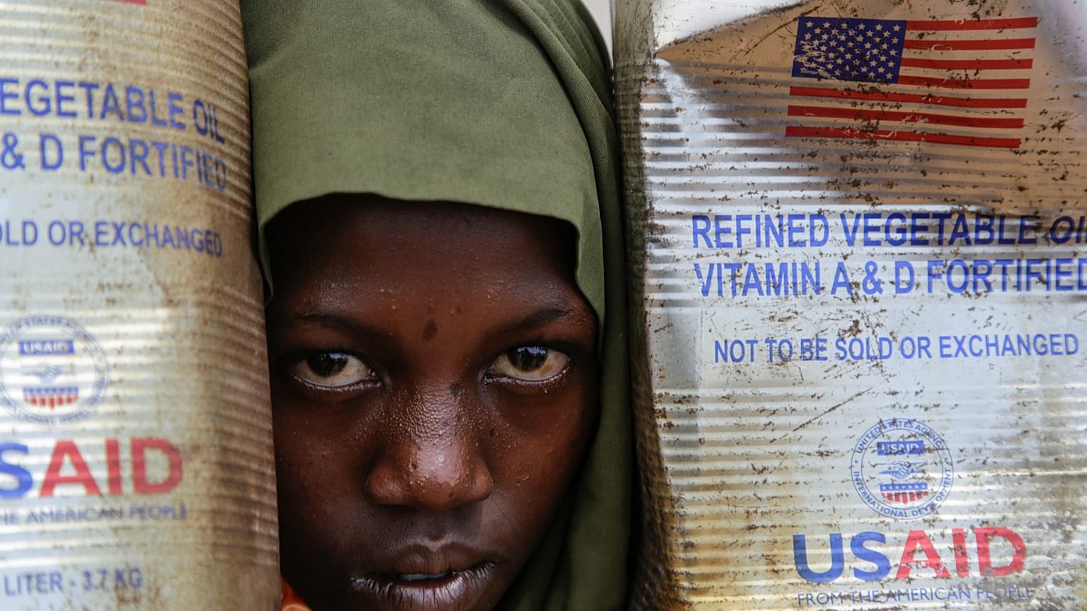 A Somali internally-displaced person (IDP) child looks out from her family's makeshift home in Maslah camp on the outskirts of Mogadishu, 5 February 2025