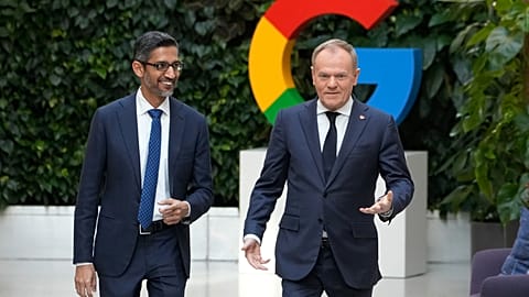 Google and Alphabet CEO Sundar Pichai, left, and Poland's Prime Minister Donald Tusk, right, at the Google Startup Centre in Warsaw on February 13, 2025 