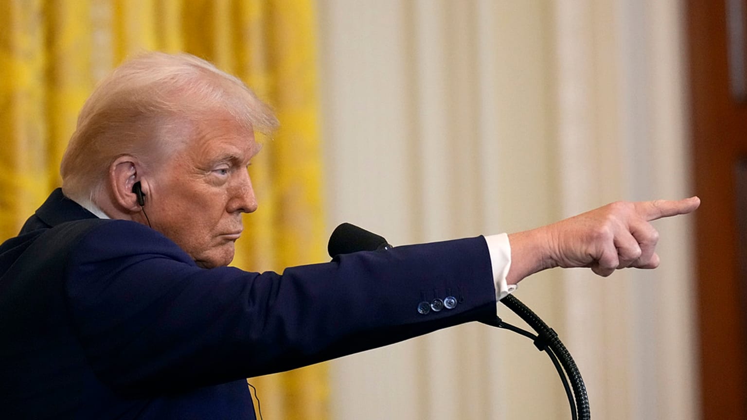 President Donald Trump points to a reporter for a question during a news conference with India's Prime Minister Narendra Modi in the East Room of the White House, Thursday, Fe