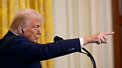 President Donald Trump points to a reporter for a question during a news conference with India's Prime Minister Narendra Modi in the East Room of the White House, Thursday, Fe