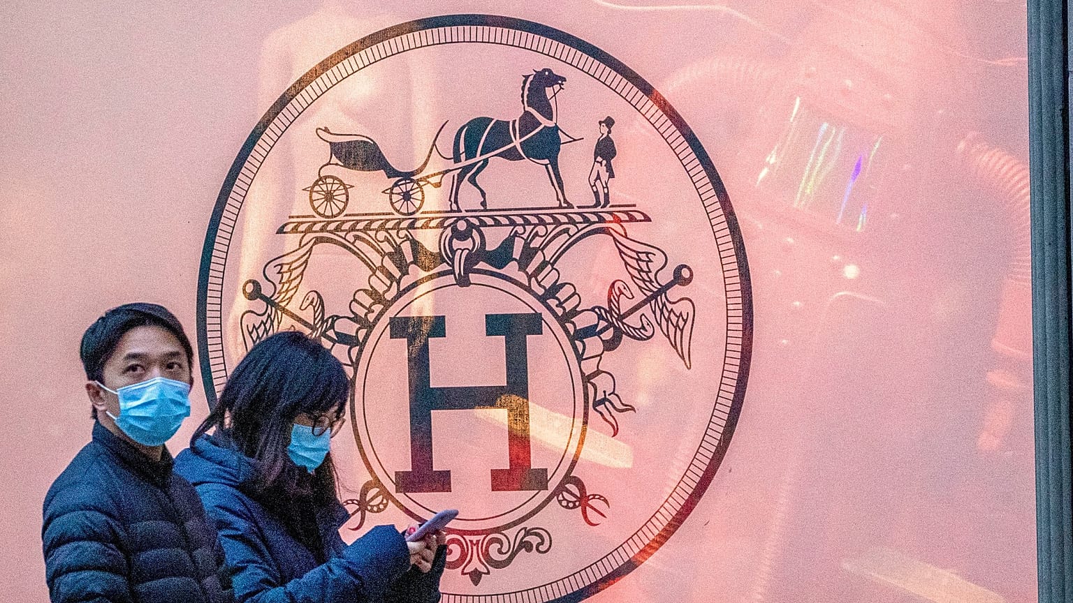 File photo of pedestrians walking past the Hermès store on Madison Avenue, Thursday, March 19, 2020, in New York, United States. 