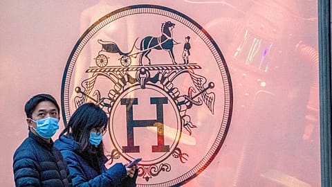File photo of pedestrians walking past the Hermès store on Madison Avenue, Thursday, March 19, 2020, in New York, United States. 
