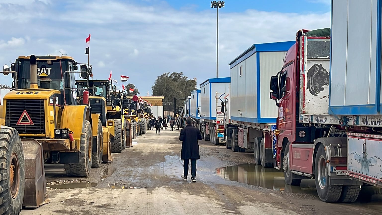 Excavadoras y camiones con convoyes esperan para entrar en Gaza en el paso fronterizo de Rafah entre Egipto y la Franja de Gaza, jueves 13 de febrero de 2025.