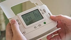 A person holding a smart meter 