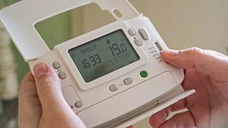 A person holding a smart meter 