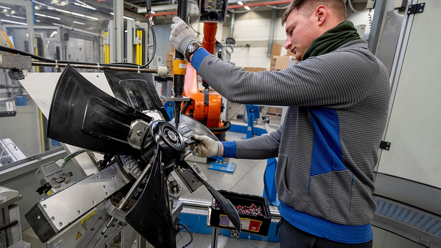 A man works on fans at an EBM-Papst plant in Hollenbach, Germany, Tuesday, Feb. 4, 2025. (
